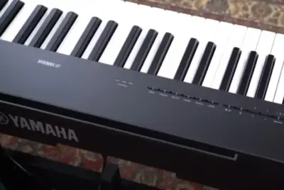 Yamaha P-225 digital piano with 88 weighted keys, sleek design, and built-in speakers, perfect for both home use and live performances